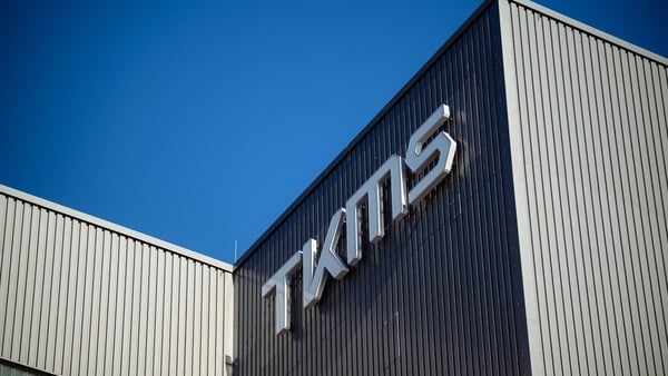 The logo of TKMS on a side of a building