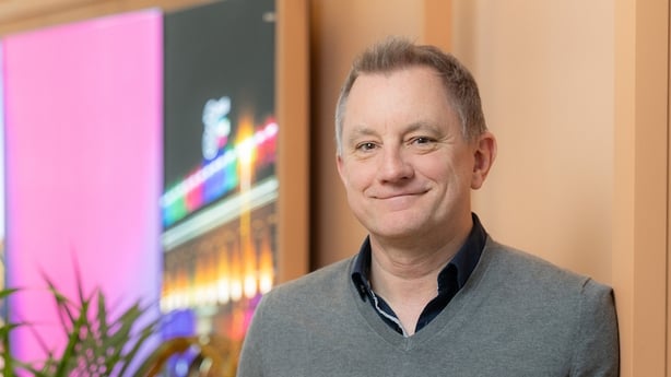 Image of a business man posing for an image in an office 
