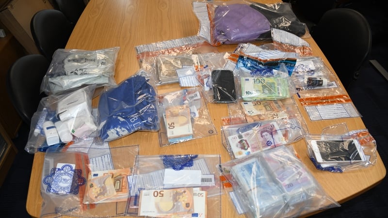 A table covered with small plastic bags of various drugs