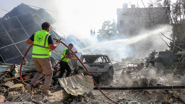 First responders affiliated with the Islamic Risala Scout Association gather at the scene following Israeli bombardment that hit one of their facilities in the village of Arnoun in southern Lebanon