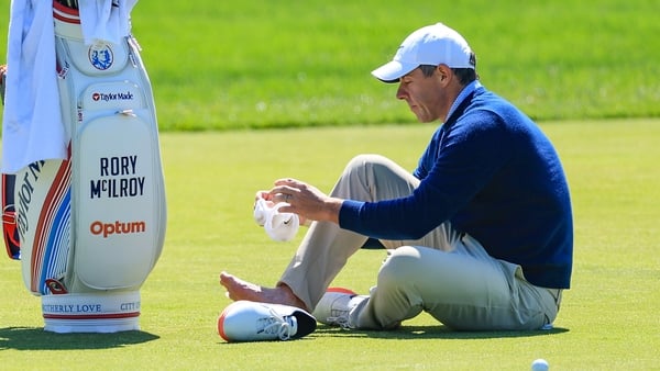 NEWTOWN, PENNSYLVANIA - MAY 12: Rory McIlroy of Northern Ireland attends to a blister on his right foot on the third hole during his practice round prior to the PGA Championship at Aronimink Golf Club on May 12, 2026 in Newtown, Pennsylvania. (Photo by Da