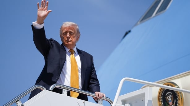President Donald Trump waves as he boards Air Force One