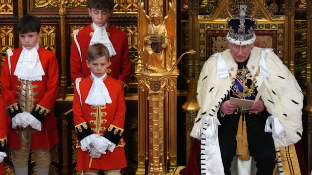 King Charles delivers the King's Speech as three page boys stand to one side