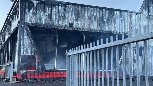 image shows a car showroom destroyed by fire