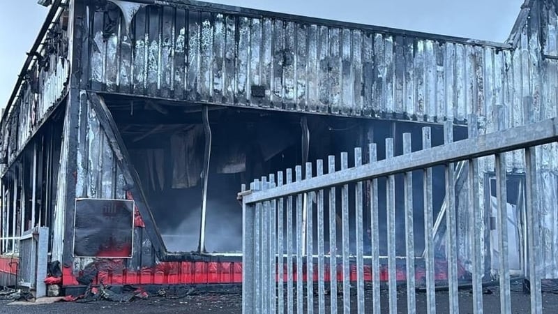 image shows a car showroom destroyed by fire