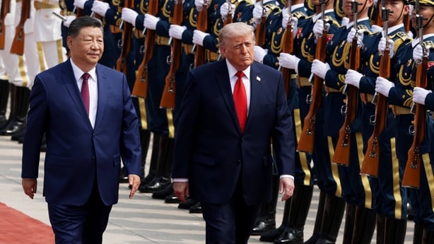 US President Donald Trump and Chinese President Xi Jinping walk by an honor guard during a welcome ceremony at the Great Hall of the People in Beijing, China.