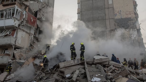 Rescuers work at a residential building partially destroyed following Russian drone and missile strikes in Kyiv