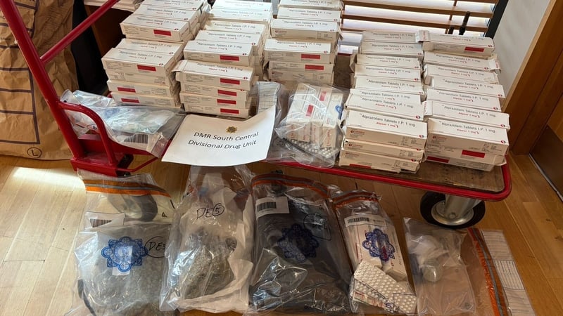 Image shows dozens of boxes of medication sitting on a trolley.