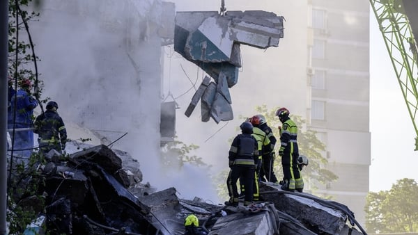 Firefighters work at the site of an apartment building damaged during a missile and drone strike in Kyiv, Ukraine, on May 14, 2026