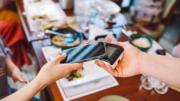 Quick payment solutions for cafe purchases. Cropped woman makes a purchase at a cafe using her phone