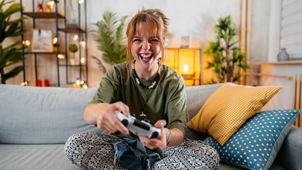 young woman playing video game at home