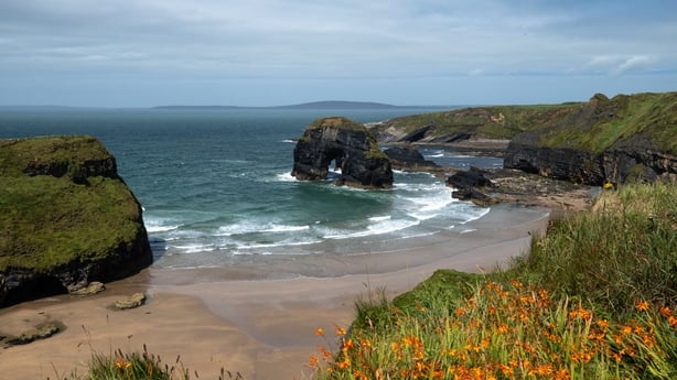 beautiful view of the beach from the Ballybunion cliffs in Ireland. blue sky and sun.