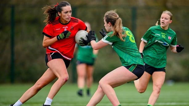 Leah Brewster (8) of Queen's University Belfast in action against Kate McEntire of the Royal College of Surgeons - 2024