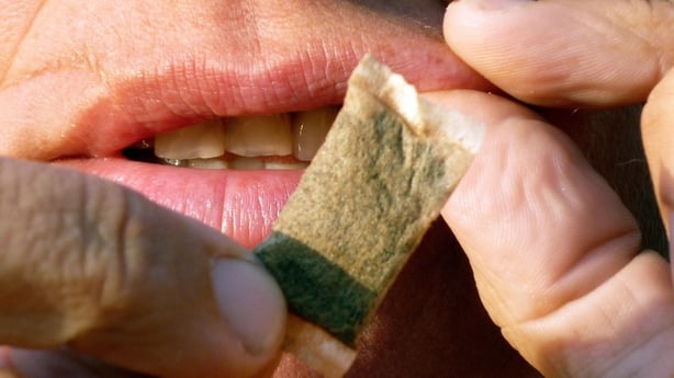 A woman shows portions of snus, a moist powder tobacco product that is consumed by placing it under the lip, in Stockholm on August 6, 2009. Sweden is trying to lift the European ban on its "snus", a sucking tobacco popular in the country and considered as smoking is being banned in public places ar