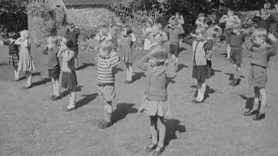 Children exercising in school garden (1966)