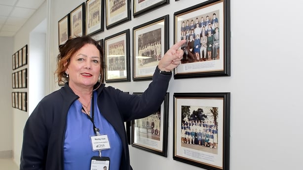 Marley Irish pointing to herself in her year's nurse graduation photo 