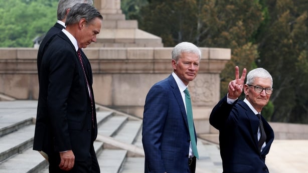 BEIJING, CHINA - MAY 14: Apple CEO Tim Cook (R) gestures next to Cargill CEO Brian Sikes (C) and Boeing CEO Kelly Ortberg as they prepare to depart following a welcome ceremony at the Great Hall of the People on May 14, 2026 in Beijing, China. President Trump is meeting with President Xi Jinping in 