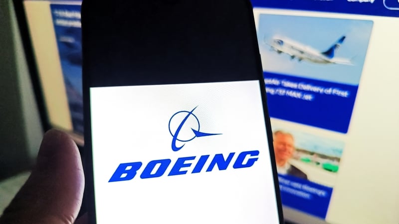 SUQIAN, CHINA - MAY 15, 2026 - A netizen is checking the BOEING logo on his mobile phone and BOEING webpage on his computer in Suqian City, Jiangsu Province, China, on May 15, 2026. (Photo credit should read CFOTO/Future Publishing via Getty Images)