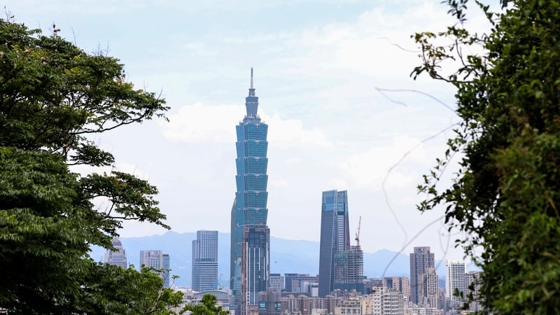 The Taipei 101 building stands among residential and commercial buildings in Taipei