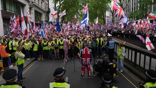 People take part in Tommy Robinson's Unite the Kingdom march in central London