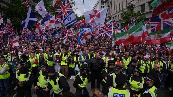 People take part in Tommy Robinson's Unite the Kingdom march in central London