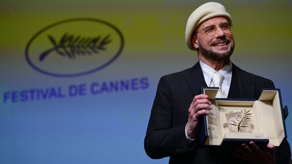 John Travolta receives his Palme d'Or award at the 79th edition of the Cannes Film Festival on 15 May, 2026. (Photo by Olivier CHASSIGNOLE/AFP)