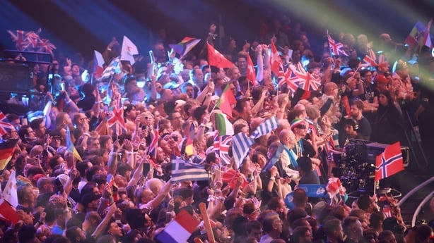 Fans wave flags during the final of the Eurovision Song Contest 2026 (ESC) at Wiener Stadthalle in Vienna, Austria on 16 May, 2026. (Photo by Radek MICA/AFP)