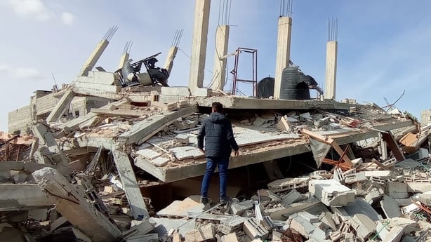Abdallah searching among the rubble in Gaza