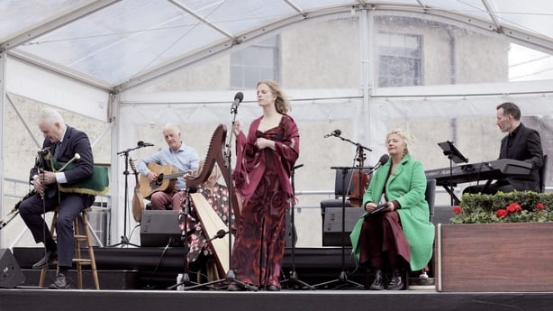 Performers playing various instruments on a stage