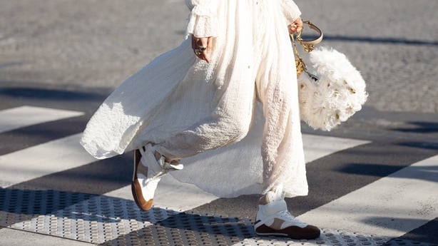 Elva Ni wears white maxi dress, gold necklace, white Chloé bag with feathers outside the Chloe fashion show during the Womenswear Fall/Winter 2025/2026 as part of Paris Fashion Week on March 06, 2025 in Paris, France. (Photo by Raimonda Kulikauskiene/Getty Images)