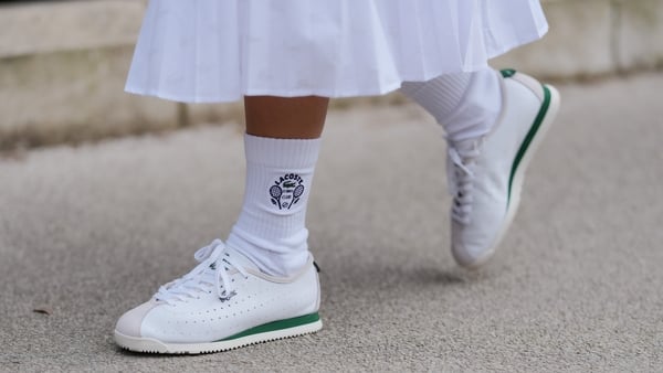 A guest wears white socks, white sneaker shoes, outside Lacoste, during the Paris Fashion week Women's Fall/Winter 2025-2026 on March 9, 2025 in Paris, France. (Photo by Edward Berthelot/Getty Images)