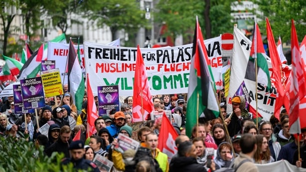 Participants waving Palestinian flags during a protest in Vienna