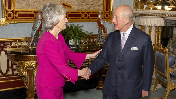 Britain's King Charles III reacts as he greets Ireland's President Catherine Connolly, during an audience at Buckingham Palace in London