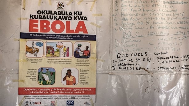 A poster displaying Ebola emergency contact numbers is pinned to a tent at the Busunga border crossing between Uganda and the Democratic Republic of Congo