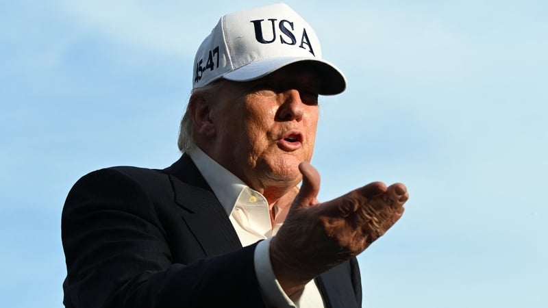 US President Donald Trump gestures as he speaks to reporters after arriving on the South Lawn of the White House