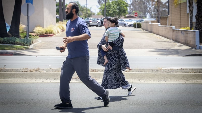 People leave the area near the Islamic Center in San Diego after multiple people were killed, including an armed security guard, after two shooters entered Islamic Center in San Diego Monday, May 18, 2026, and opened fire. The shooting occurred while a K