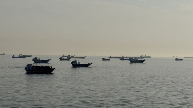 Vessels are seen anchored in the Strait of Hormuz, off the port city of Khasab on Oman's northern Musandam Peninsula on May 17, 2026. Washington, locked in conflict with Tehran since US and Israeli forces launched major strikes on the Islamic republic beginning February 28, has struggled to break an