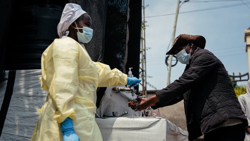A visitor washes his hands before entering a hospital in DR congo