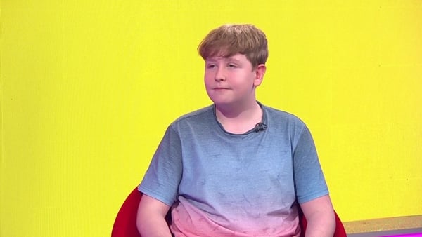 Finn Healy in the news2day studio talking about World IBD Day - yellow background.