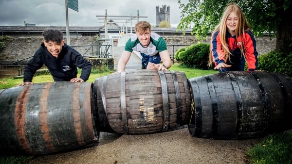 Children rolling barrels in Limerick