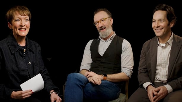 Aedín Gormley interviews John Carney and Paul Rudd. Aedín is looking at them smiling and they are looking back at her smiling