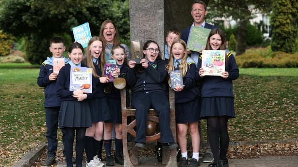 Picture shows Elaina Ryan, CEO of Children's Books Ireland, Tom Woods, Head of Clients KPMG and reading Hero Winner - student Caoilfhionn Carlin with some of her class mates.