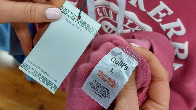 A Made in Ireland swing tag with Made in Pakistan label on Quills clothing