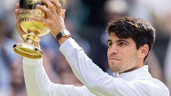 Carlos Alcaraz of Spain holds aloft the winners trophy after defeating Novak Djokovic of Serbia at the Mens Singles Final against at The Wimbledon Lawn Tennis Championship at the All England Lawn and Tennis Club at Wimbledon on July 14th, 2024 in London,