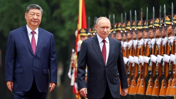 Russia's President Vladimir Putin and China's President Xi Jinping inspect a honour guard