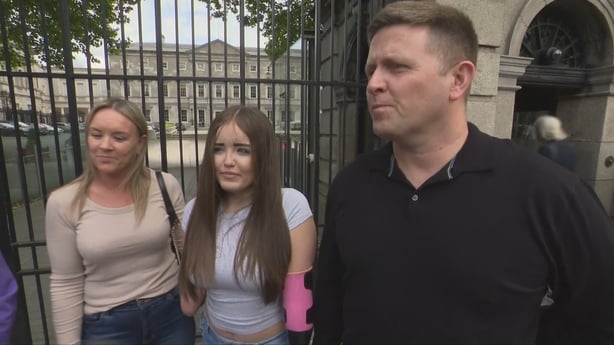 Sophie Lanigan, centre, with her parents Laura and Keith