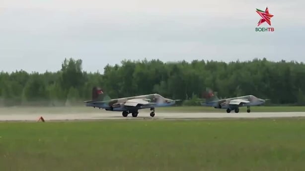 Two military planes on a runway