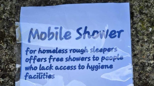 Close up image of a laminated piece of paper explaining how to use a mobile shower for homeless people.