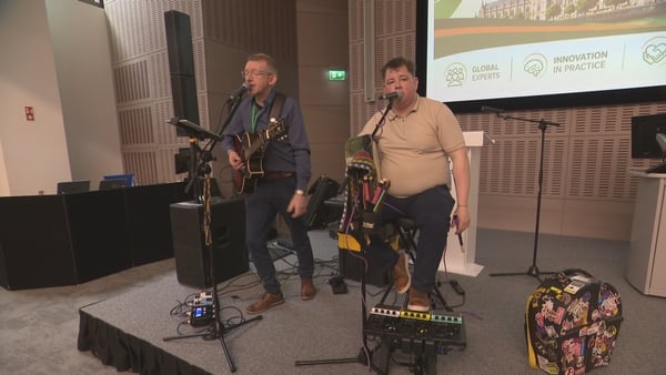 James Kelly (right) playing the bodhrán on stage at the conference