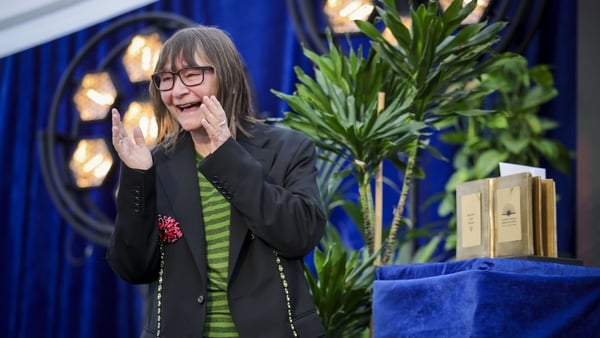 Woman reacts with hands up and big smile